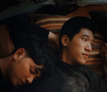 Two Asian men lying side by side. How to deal with a breakup by Stephanie Ambrosius
