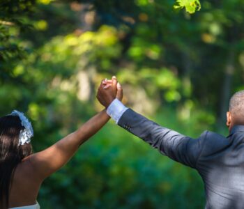 Woman and Man holding hands in air at wedding. 10 Lessons to Transform Your Marriage